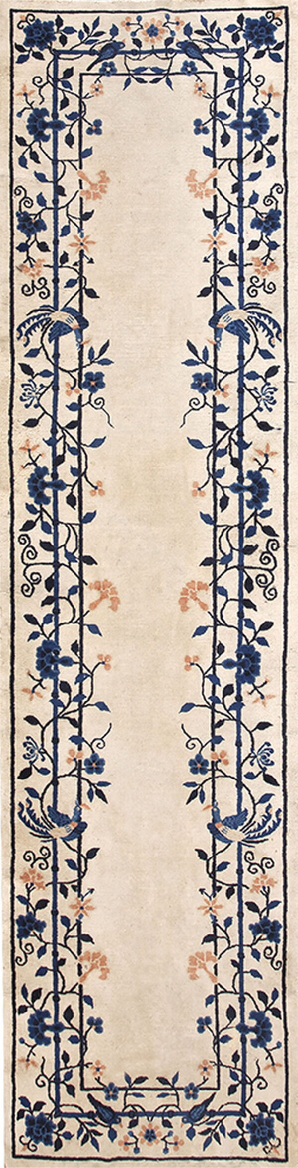 Beige runner rug with symmetrical blue and coral botanical patterns framing a wide central panel.
