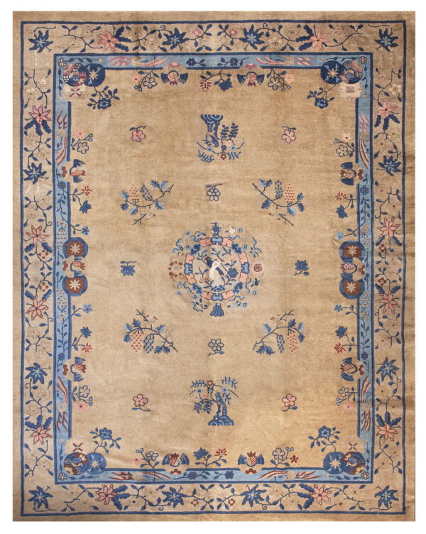 Low pile tan rug with an intricate blue and pink botanical pattern and complex border design.