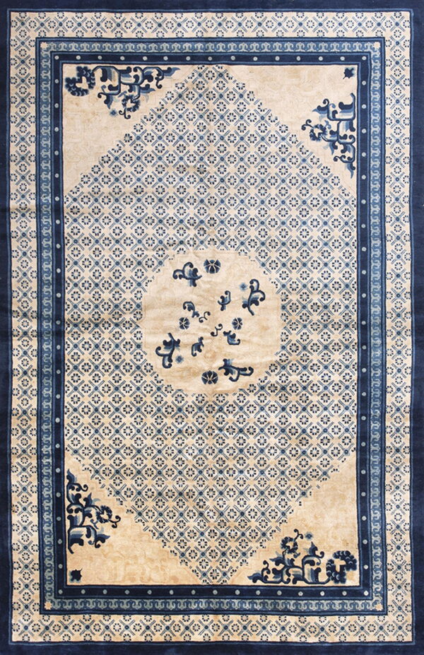 Beige and blue rug featuring a central medallion and small repeating motifs within a dark blue border.
