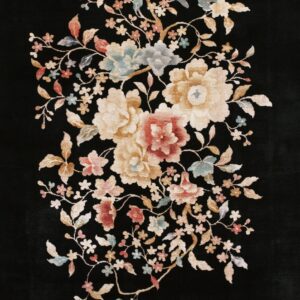 Black rug featuring a central bouquet of large floral motifs in cream, gold, red, and pale blue.