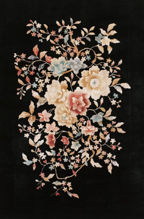 Black rug featuring a central bouquet of large floral motifs in cream, gold, red, and pale blue.