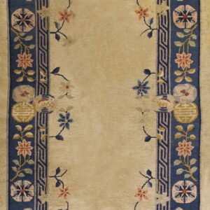 Long cream-colored runner with a floral spray pattern bordered by thick navy bands and geometric designs.