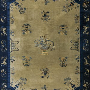 Olive green area rug with a navy blue border displaying detailed blue and gold floral patterns.