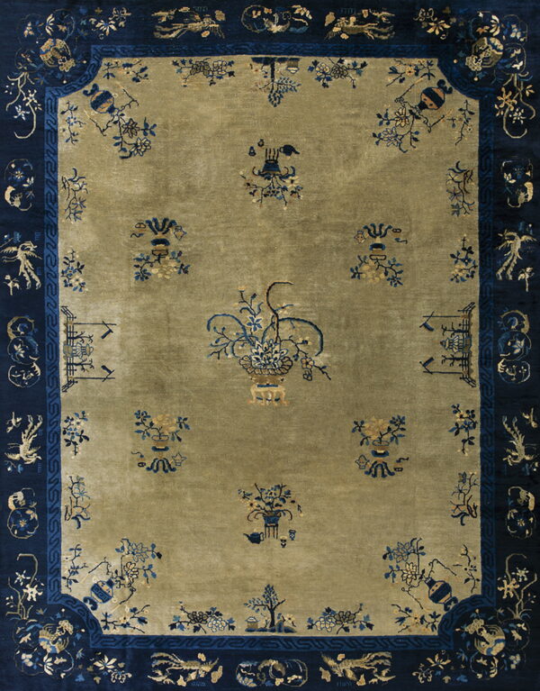 Olive green area rug with a navy blue border displaying detailed blue and gold floral patterns.