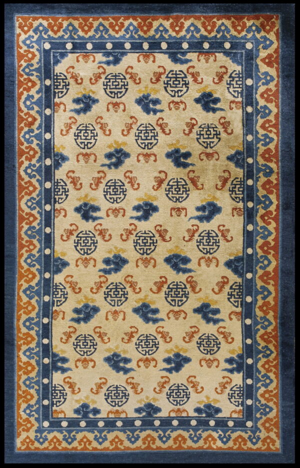 Beige rug with repeating blue medallion and cloud patterns, framed by a multi-layered blue and rust border.