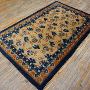 Beige rug featuring blue and orange medallion and cloud patterns, surrounded by a navy border.