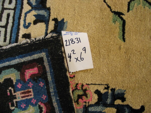 A close-up shows a tan patterned rug next to a folded edge with geometric blue and pink designs.