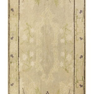 A long beige runner rug features abstract botanical designs in faded green and subtle purple accents.