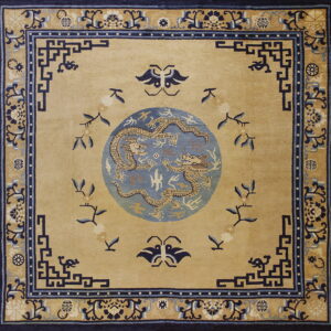 Tan square rug with a central blue dragon medallion and intricate dark blue geometric and floral borders.