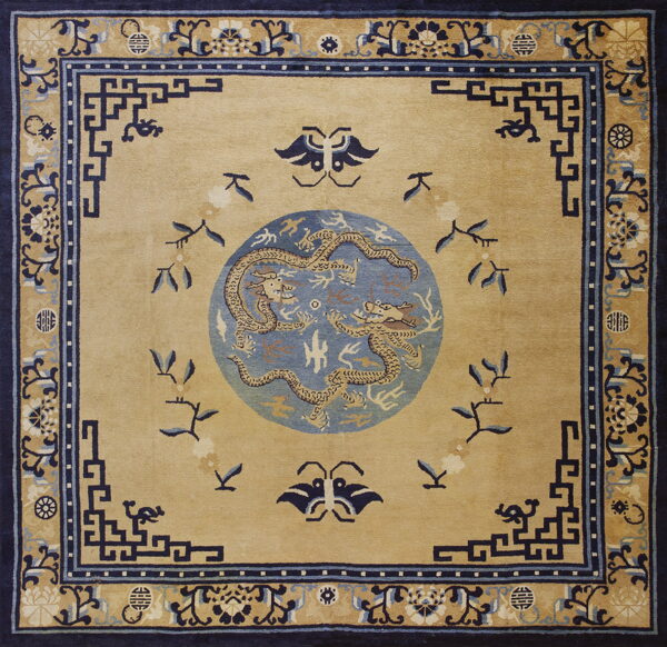 Tan square rug with a central blue dragon medallion and intricate dark blue geometric and floral borders.