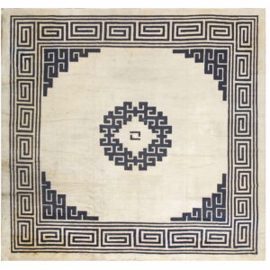 Off-white square rug with black Greek key borders and a geometric center motif.