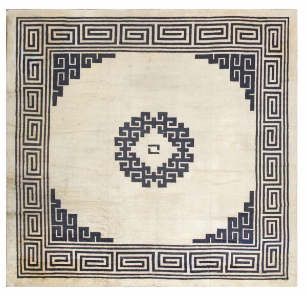 Off-white square rug with black greek key borders and a geometric center motif.