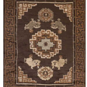 Dark brown rug featuring a geometric meander border surrounding central medallions and stylized light tan animals.