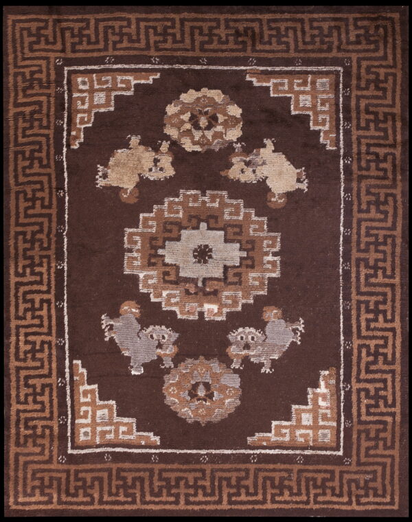 Dark brown rug featuring a central geometric medallion and four stylized figures framed by a tan fret border.