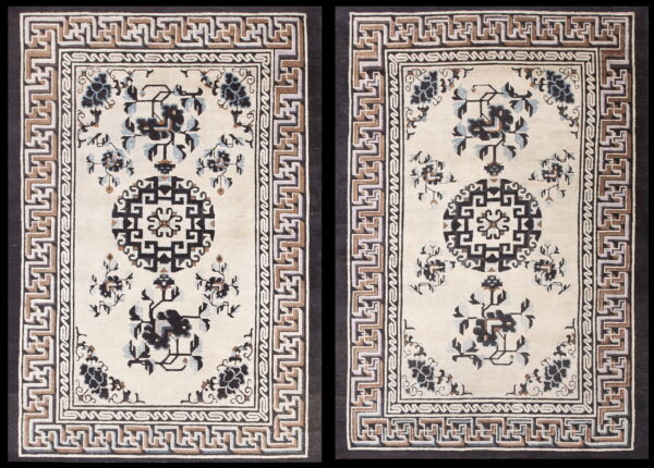 Pair of cream rugs with dark floral motifs, black medallions, and geometric meander borders.