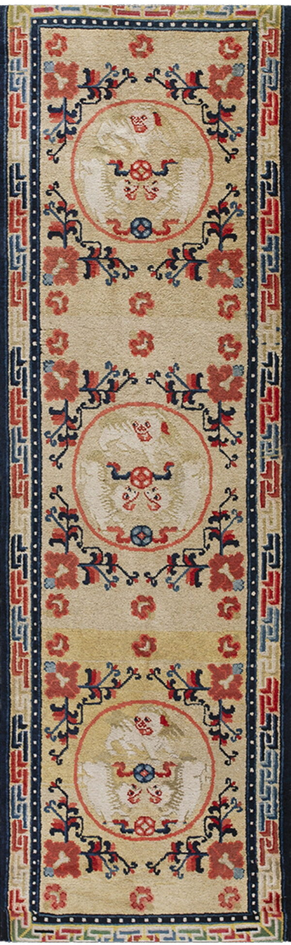 Beige runner rug with three stylized medallions, red and blue floral accents, and a dark blue geometric border.