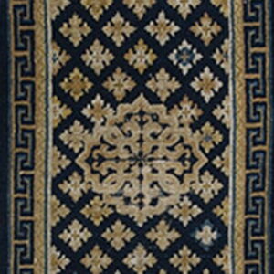 Navy blue runner rug featuring tan lattice and medallion motifs bordered by a geometric Greek key pattern.