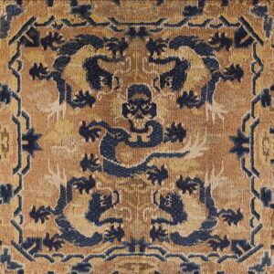 Intricate blue and tan high-pile rug detail showing stylized animal figures and a geometric border design.