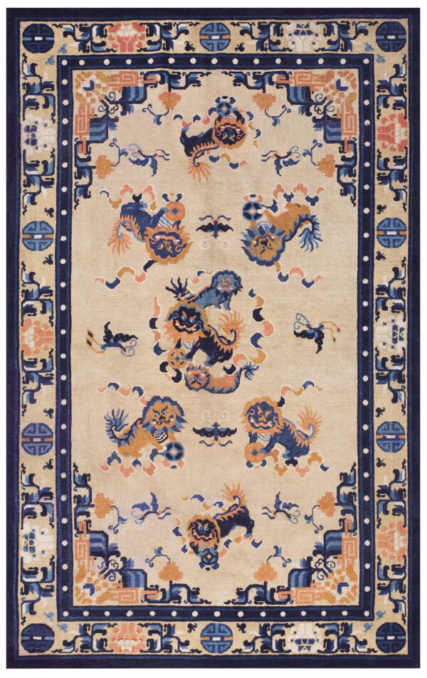 Low-pile rug with a beige field, navy border, and colorful blue and orange guardian lion designs.