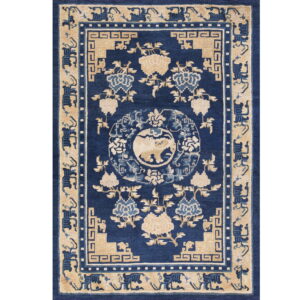 Deep blue rug with tan and light blue floral designs and a central animal medallion.