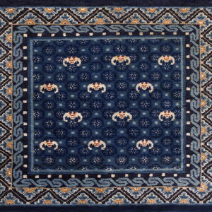A deep blue rug featuring highly detailed geometric and floral patterns with light blue and tan accents.