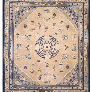 Beige traditional rug featuring a navy blue medallion, scattered motifs, and complex multi-layered borders.