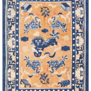 Orange field rug featuring a large blue stylized dog surrounded by clouds, scrolls, and a key-pattern border.