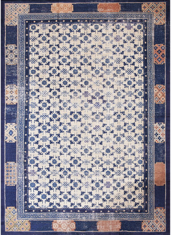 Blue and cream low-pile rug with geometric patterns and a complex border featuring terracotta accents.