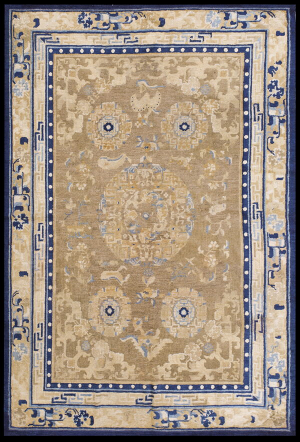 Tan and beige traditional rug featuring dark blue borders and ornate floral medallion patterns.