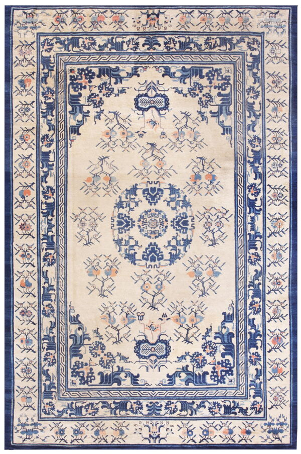 Ivory rug with complex navy blue borders, a central medallion, and scattered floral motifs in blue and coral.