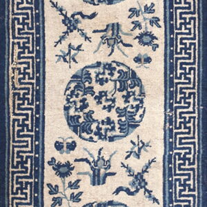 Blue and cream runner rug featuring three circular medallions and a wide geometric fret border.