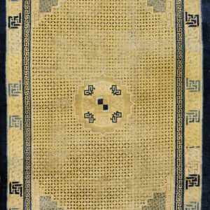Gold rug with dense dot patterns and wide geometric borders in dark navy, light blue, and yellow.