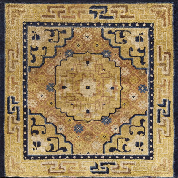 Golden yellow and indigo rug with a prominent geometric center and fret patterned borders.