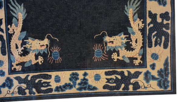 Antique chinese - ningxia hallway runner wool blue rug 5 Dark blue rug detail showing two tan dragons facing a dark field and a detailed border.