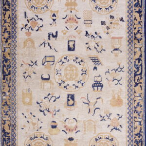Cream rug with navy blue, tan, and light pink scattered motifs and a complex multi-layered border.