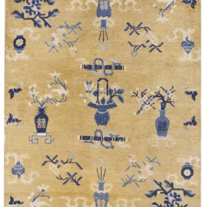 Golden yellow rug featuring dense blue and cream floral and decorative vase motifs.