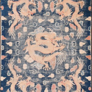 Dark blue rug featuring light pink dragon and cloud motifs in a detailed, distressed pattern.