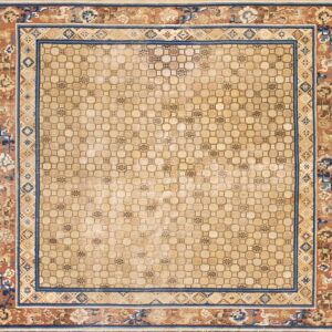 Beige rug with an interlocking geometric field and wide navy and terracotta floral border.