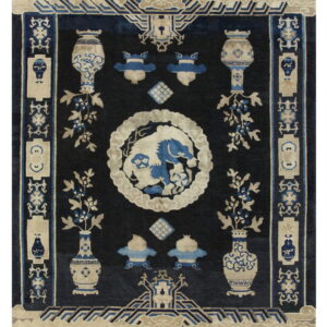 Dark blue rug with beige and light blue traditional motifs, including vases, a central creature, and borders.