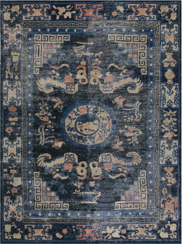 Distressed blue rug featuring complex traditional motifs, a central medallion, and a detailed geometric border.