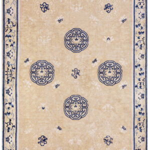 A beige rug with four navy blue circular medallions and a wide blue floral border.