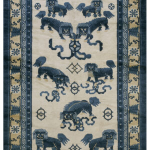 Blue mythological lions and knotwork pattern on a cream field with elaborate tan and navy borders.