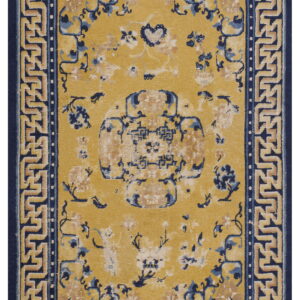 Gold rug with distressed blue and tan floral motifs bordered by a navy blue geometric Greek key design.