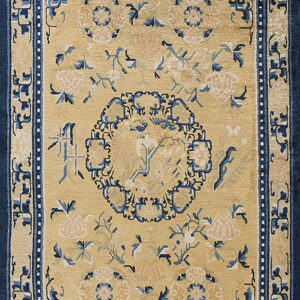 Camel rug with a dark blue border and central medallion surrounded by stylized flowers and birds.