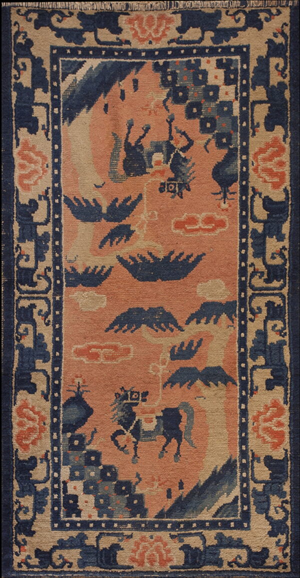 Rectangular rug with a coral field featuring stylized indigo animals and clouds, framed by a wide beige and blue border.