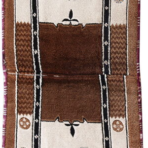 Cream and brown runner rug displaying spotted deer, blue trees, and intricate patterned medallions along the edges.