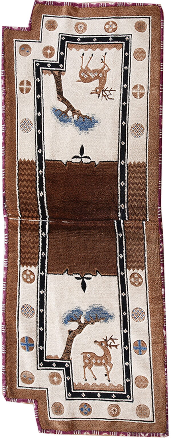 Cream and brown runner rug displaying spotted deer, blue trees, and intricate patterned medallions along the edges.