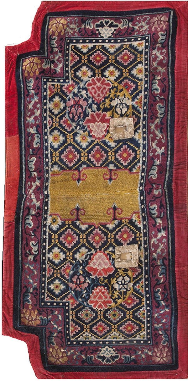 Blue rug fragment with detailed floral motifs, a gold central band, red borders, and surface patches.