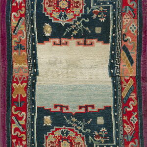 Red and indigo rug with a central ivory stepped niche framed by complex floral and geometric borders.