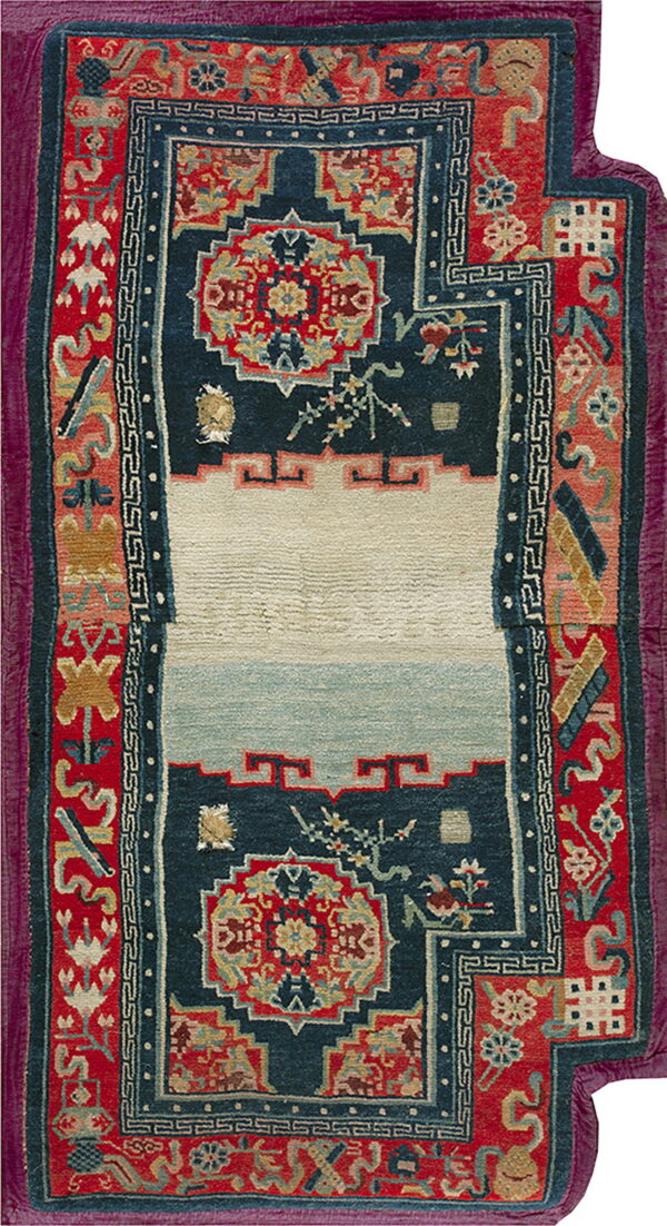 Red and indigo rug with a central ivory stepped niche framed by complex floral and geometric borders.
